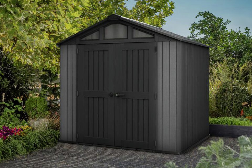 Keter Stronghold 8x8 Apex Shed surrounded by plants.